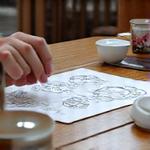Client discussing cake ideas with a designer over sketches