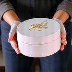 Professionally delivered cake box being carefully placed at a celebration venue